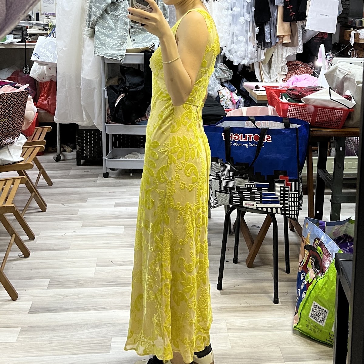 A customer in a yellow devore velvet dress inside the workshop