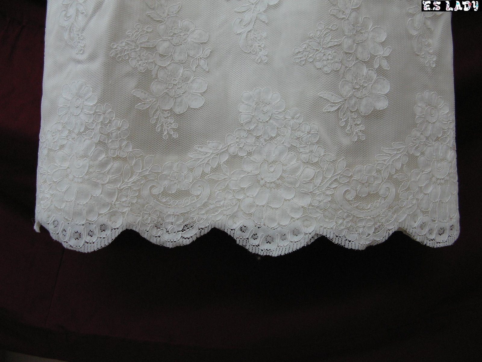 Scalloped lace hem detail on a custom garment