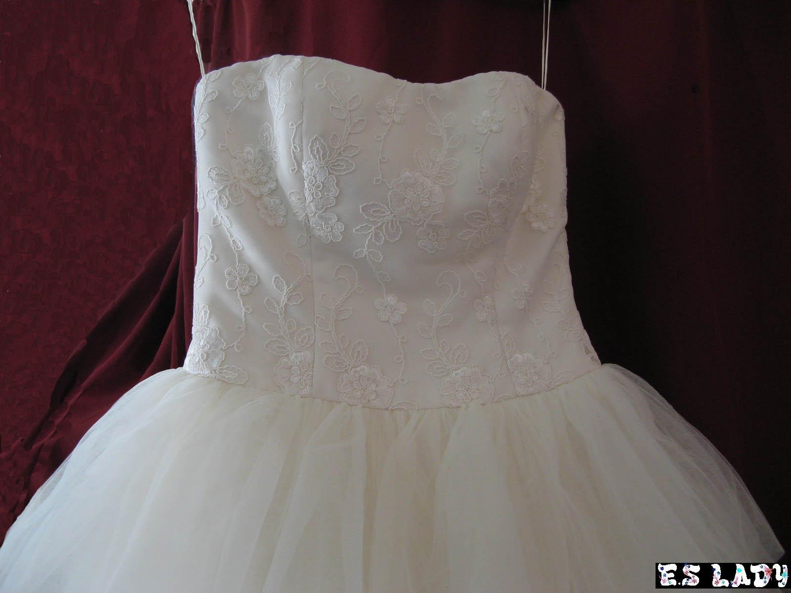 Strapless wedding gown with a lace applique bodice and tulle skirt, made in the atelier